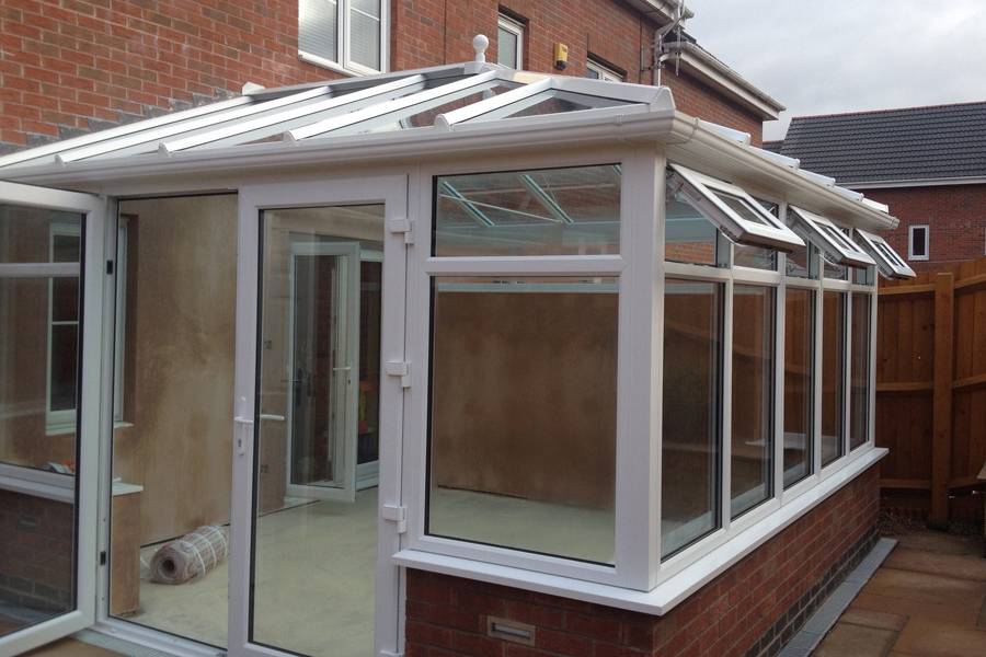 white upvc conservatory with white upvc french doors and windows